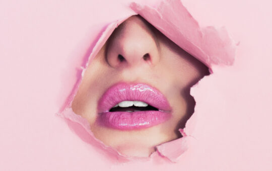 Lips through ripped paper
