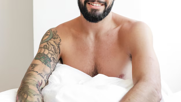 Shirtless man sitting upright in bed