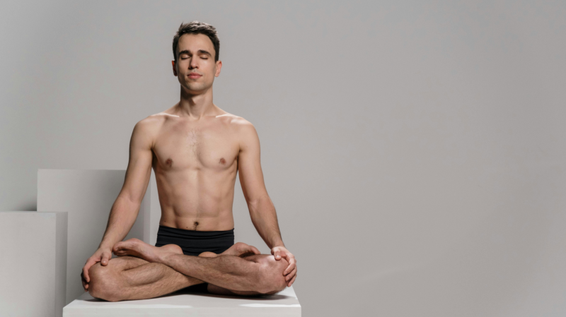 Alt: Shirtless man meditating