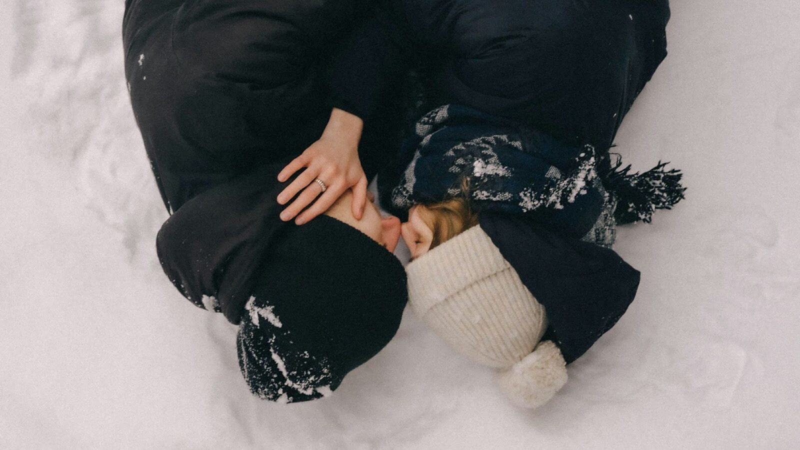couple kissing in snow, article about ice butt plugs