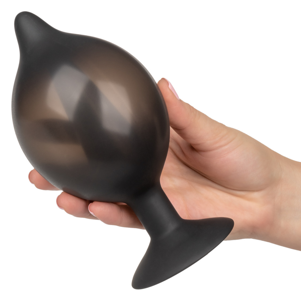 hand holding a large inflatable butt plug