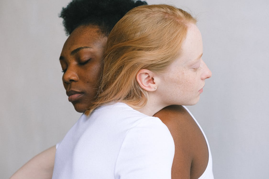 lesbian couple holding each other with reference to mutual mastubation article