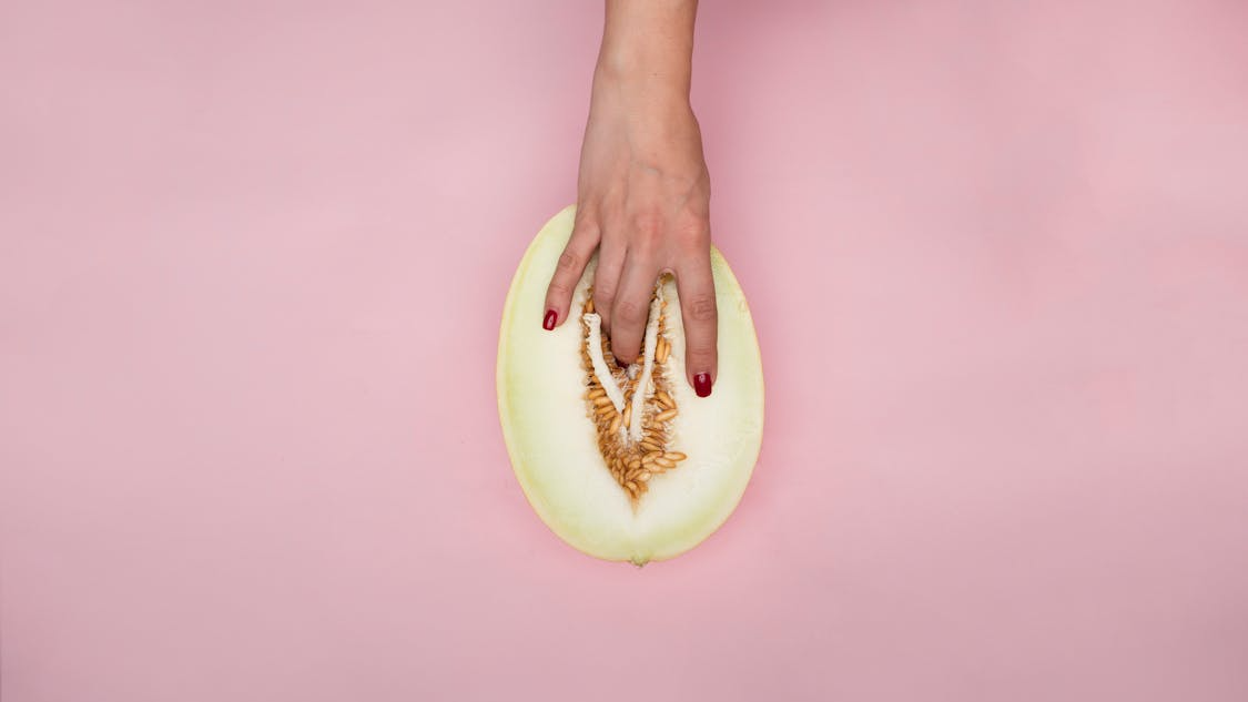fingers in a melon to insinuate female masturbation