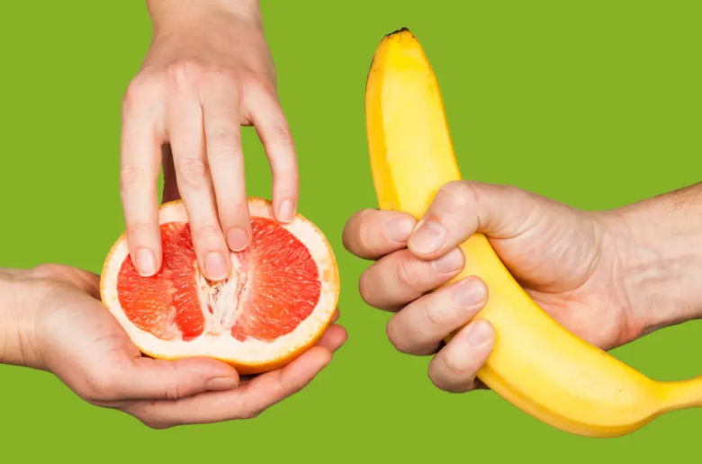 hands holding fruit to insinuate mutual masturbation