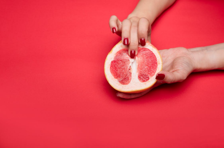 woman touching a grapefruit - masturbation innuendo