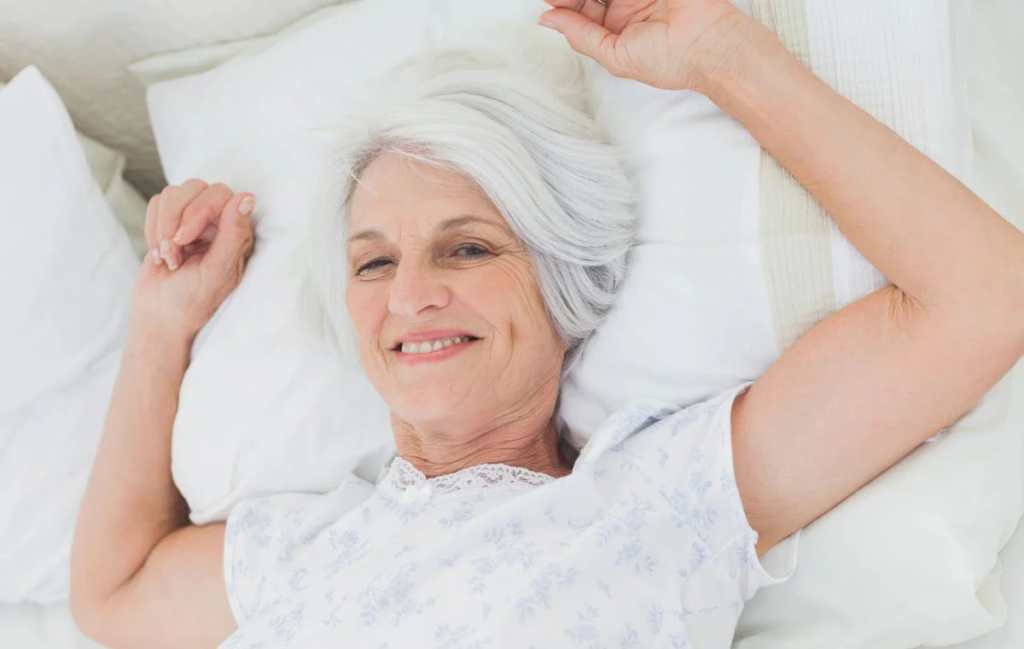 mature woman in bed smiling