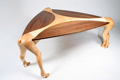 A wooden table with women's legs as erotic furniture