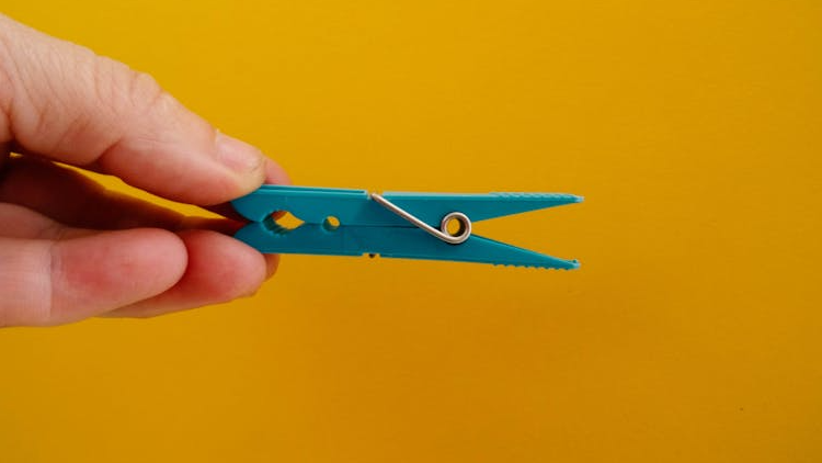 blue clothespin on yellow background for BDSM clothespins article content