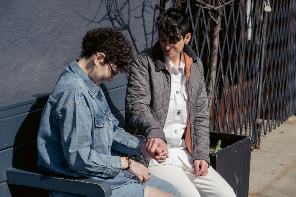 Lesbian couple holding hands during kink talk