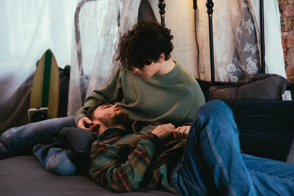 gay couple in bed holding each other