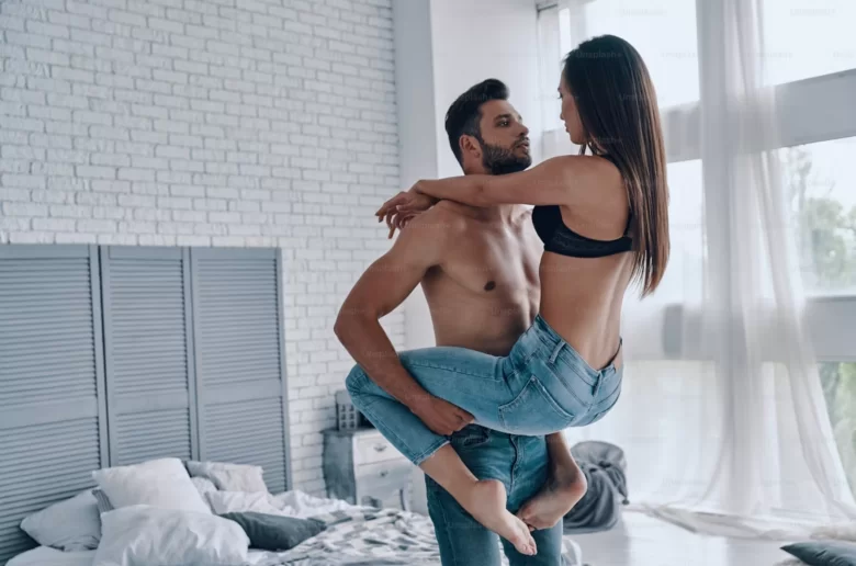 Standing man holding a woman up with her legs around his waist, standing sex cover image