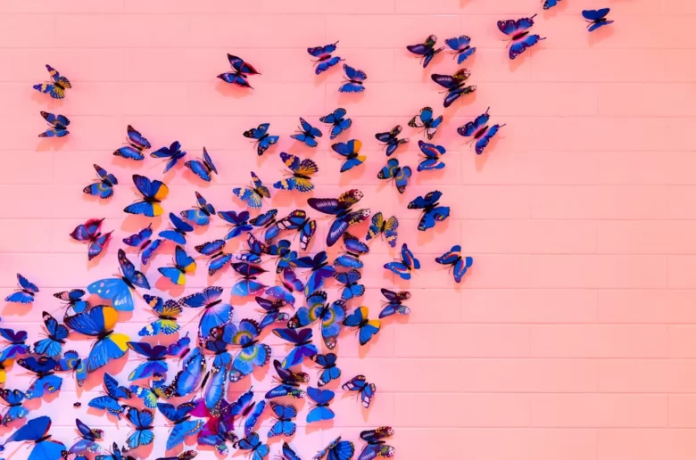 blue butterflies on pink background, cover image for butterfly sex position article